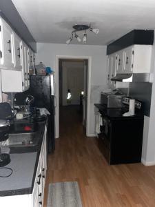 a kitchen with black counters and a black refrigerator at Dayton get away in Dayton