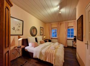 a bedroom with a large bed in a room at Halbinsel am See in Blieskastel