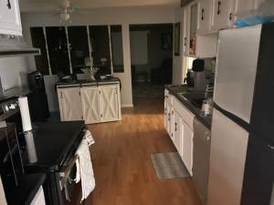 a kitchen with white cabinets and a white refrigerator at Dayton get away in Dayton +2 photos