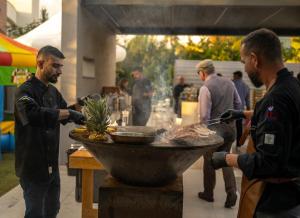 a group of men cooking food in a grill at Seaview Luxury Villa Fortuna in Ayia Napa +281 photos