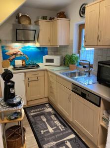 a kitchen with a sink and a microwave at Ferienwohnung Erika in Marquartstein