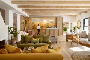 een woonkamer met 2 banken en een keuken bij Spier Hotel and Wine Farm in Stellenbosch