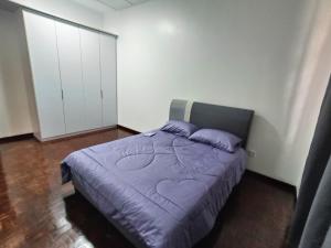 a bedroom with a bed with a purple blanket at Paradigm Mall-Skudai-Sutera-Johor Bahru-K&A Homestay-12 pax in Johor Bahru