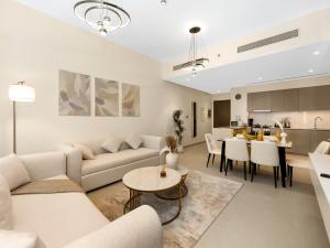 a living room with a couch and a table at EMAAR GRANDE 1BR Downtown I Steps to Fountain & Dubai Mall in Dubai