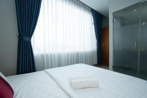 Postel nebo postele na pokoji v ubytování The Eros Hotel