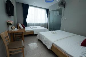 Postel nebo postele na pokoji v ubytování The Eros Hotel
