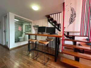 a home office with a desk with two monitors on it at April Fair Duplex Apartment Guagnzhou South Railway Station Min Jie Branch in Guangzhou