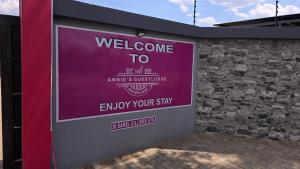 a welcome to sign on the side of a building at Annie's Guest Lodge in Volksrust +12 photos