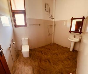 a bathroom with a toilet and a sink at New Runaliya in Anuradhapura
