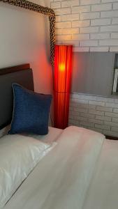 a bedroom with a bed with a red lamp at April Fair Duplex Apartment Guagnzhou South Railway Station Min Jie Branch in Guangzhou