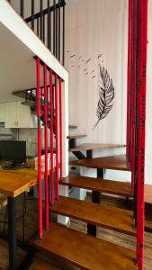 a staircase with red railings in a room at April Fair Duplex Apartment Guagnzhou South Railway Station Min Jie Branch in Guangzhou