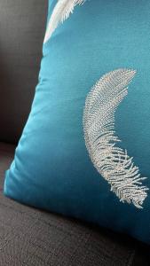 a blue pillow with a white bird design on it at April Fair Duplex Apartment Guagnzhou South Railway Station Min Jie Branch in Guangzhou