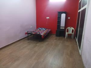 a room with a bed and a chair in it at Sunbeam Stay in Prayagraj