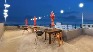 a group of tables and chairs on a roof at Gangneung Glad Pension in Gangneung