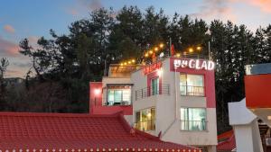 a building with a sign on top of it at Gangneung Glad Pension in Gangneung