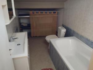 a small bathroom with a toilet and a sink at Maison 2 faces Argeles Centre Ville in Argelès-sur-Mer