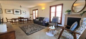 a living room with a couch and a fireplace at Sandstone Suites - In the heart of Port Fairy in Port Fairy