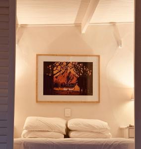 a bedroom with a picture above a bed at Le Grenier Luxury Loft in Franschhoek