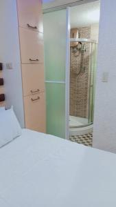 a bedroom with a white bed and a mirror at Lovely house in Pagadian city in Norte +23 photos