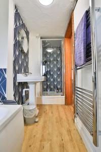 a bathroom with a sink and a mirror at West Hollowcombe Farm Cottages - full site booking in Dulverton +39 photos