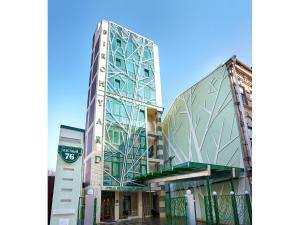 a tall glass building next to another building at Birch Yard Hotel in Rostov on Don