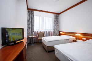 Postel nebo postele na pokoji v ubytování Harmony Club Hotel