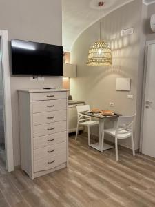 a kitchen and dining room with a table and a tv at RC Sardinia in Sorso