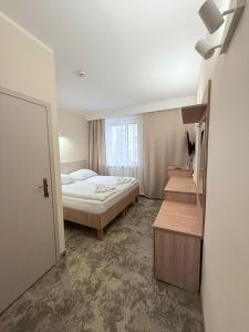 Posteľ alebo postele v izbe v ubytovaní Hotel TM