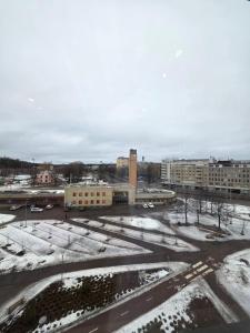 an empty parking lot with snow on the ground at Yksiö kahdelle hengelle keskellä Lahtea in Lahti