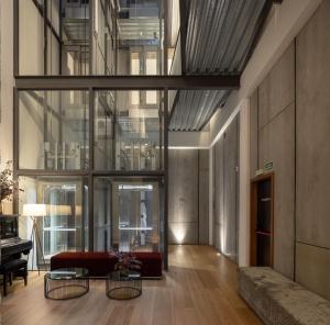 a living room with a couch and a table at Hotel Tayko Bilbao in Bilbao +94 photos