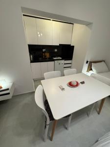 a white table and chairs in a room with a kitchen at Private Villa Aras 2 - Luxury & Elegance Apartments in Vlorë +17 photos