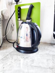 a black tea kettle with a picture on it at Kempas - 21 Pax Villa, Near Paradigm Mall JB in Johor Bahru
