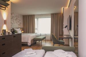 Voodi või voodid majutusasutuse Hotel DAS SAAL toas