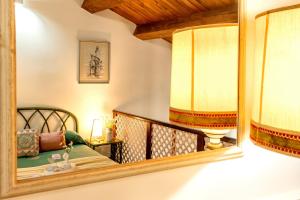 Un espejo en una habitación con una cama y un sofá. en SARDINIA RE - Loft Antica Italia, en Sassari 36 fotos más