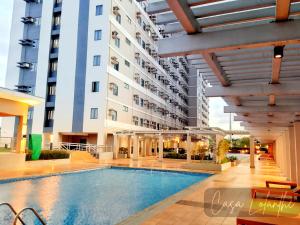 a swimming pool in front of a building at Casa Lolanthe Fully Furnished Studio Unit in Pasong Bayog