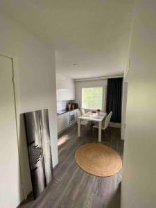 a living room with a table and a kitchen at Modern apartment- great equipment - Smart TV -Fast Wifi, Close to the center in Lappeenranta