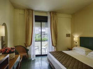 a hotel room with a bed and a balcony at Hotel Cristallo in Giulianova