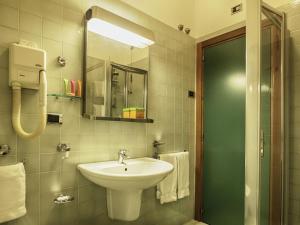 a bathroom with a sink and a mirror at Hotel Cristallo in Giulianova