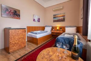 A bed or beds in a room at Hotel Kristal Gellért Hill