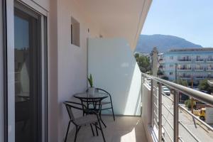 a balcony with a table and chairs on a balcony at Golden sand apartment A in Hersonissos