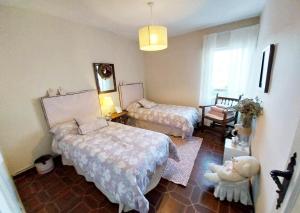 a bedroom with two beds and a stuffed animal in it at Increible casa de campo, 5 DORM, MARCO INCOMPARABLE in Pareja +50 photos
