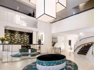 a lobby with a large circle in the middle of a room at The 1932 Hotel & Spa Cap d'Antibes - MGallery Collection in Juan-les-Pins