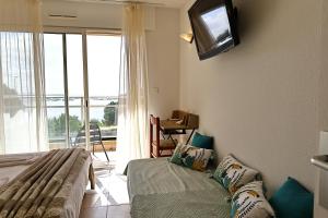 Televízia a/alebo spoločenská miestnosť v ubytovaní T2 Dolce Vita - Vue Mer, Piscine & Plage