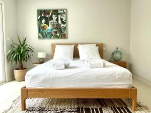 a bedroom with a large bed with white sheets at PGH N2 - Villa avec Piscine à 50m de la Plage in La Grande-Motte +44 photos