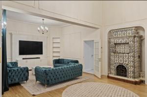 a living room with two blue couches and a fireplace at White luxury house in Bucharest