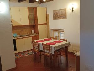 a kitchen with a table and chairs in a room at Blue Lake House in Iseo