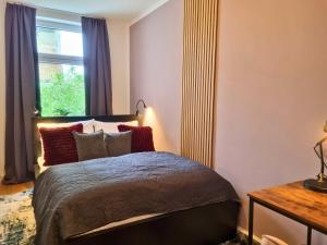 a bedroom with a bed and a window at maremar - Style-Loft am Ferberturm - 2 Schlafzimmer - Luxus Boxspringbett - Arbeitsplätze - Highspeed WLAN in Gera