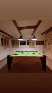 a ping pong table in a room with at Family Home Iskra in Bulić