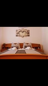 a bedroom with a large wooden bed with two pillows at Family Home Iskra in Bulić +19 photos