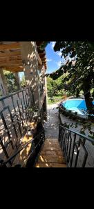a porch with a bench and a swimming pool at Sentyab Obi chashma guest house in Tadzhimi